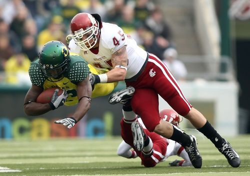 andy mattingly ed dickson #83 of the oregon ducks is tackled by