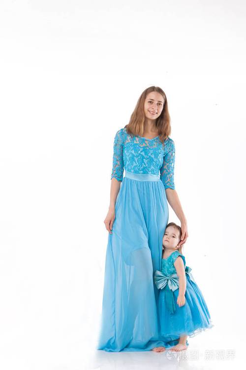 母亲和孩子在白色背景上摆姿势穿蓝色裙子的女人