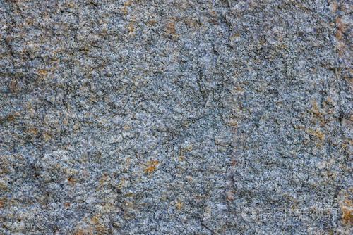 具有多孔表面的花岗岩岩石. 来自实心石头的背景. 天然材料图案