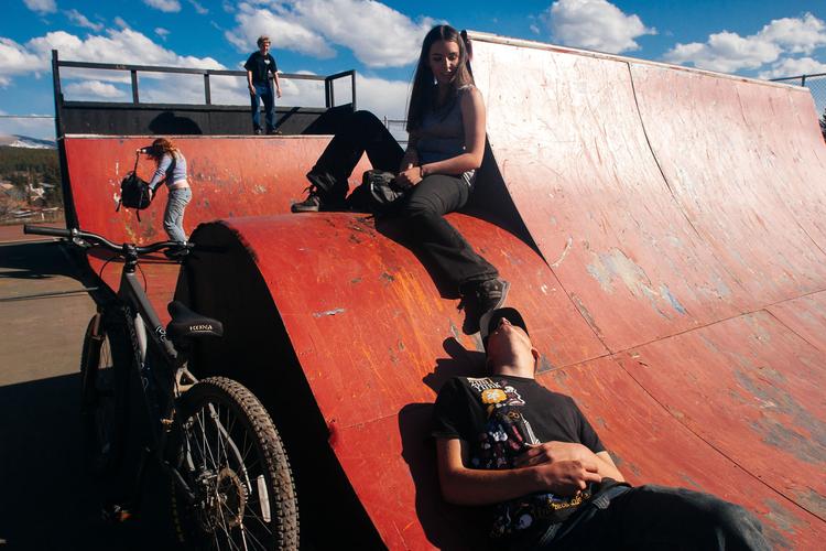 elaina and jacob hang out with friends on a weathered skate ramp