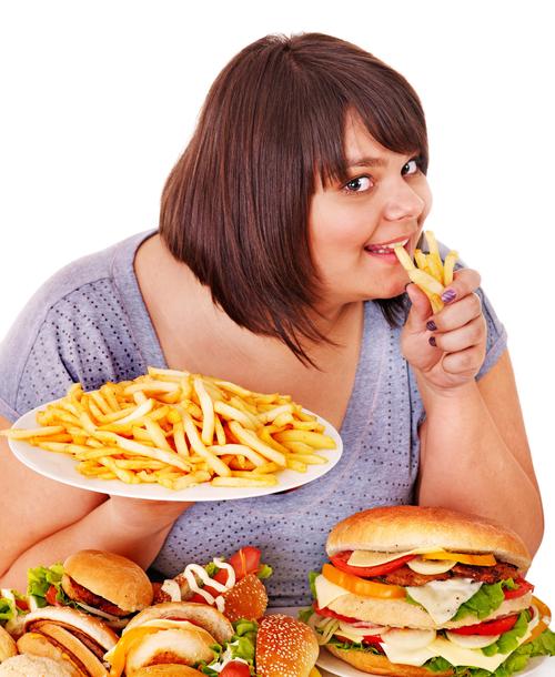 白底吃着西式垃圾食品快餐的肥胖女生