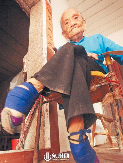 泉州三姐妹300岁 老人安静地坐在椅子上,看着门前的