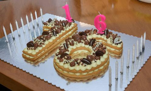 原甜十六岁生日蛋糕,用巧克力糖果和蜡烛装饰照片